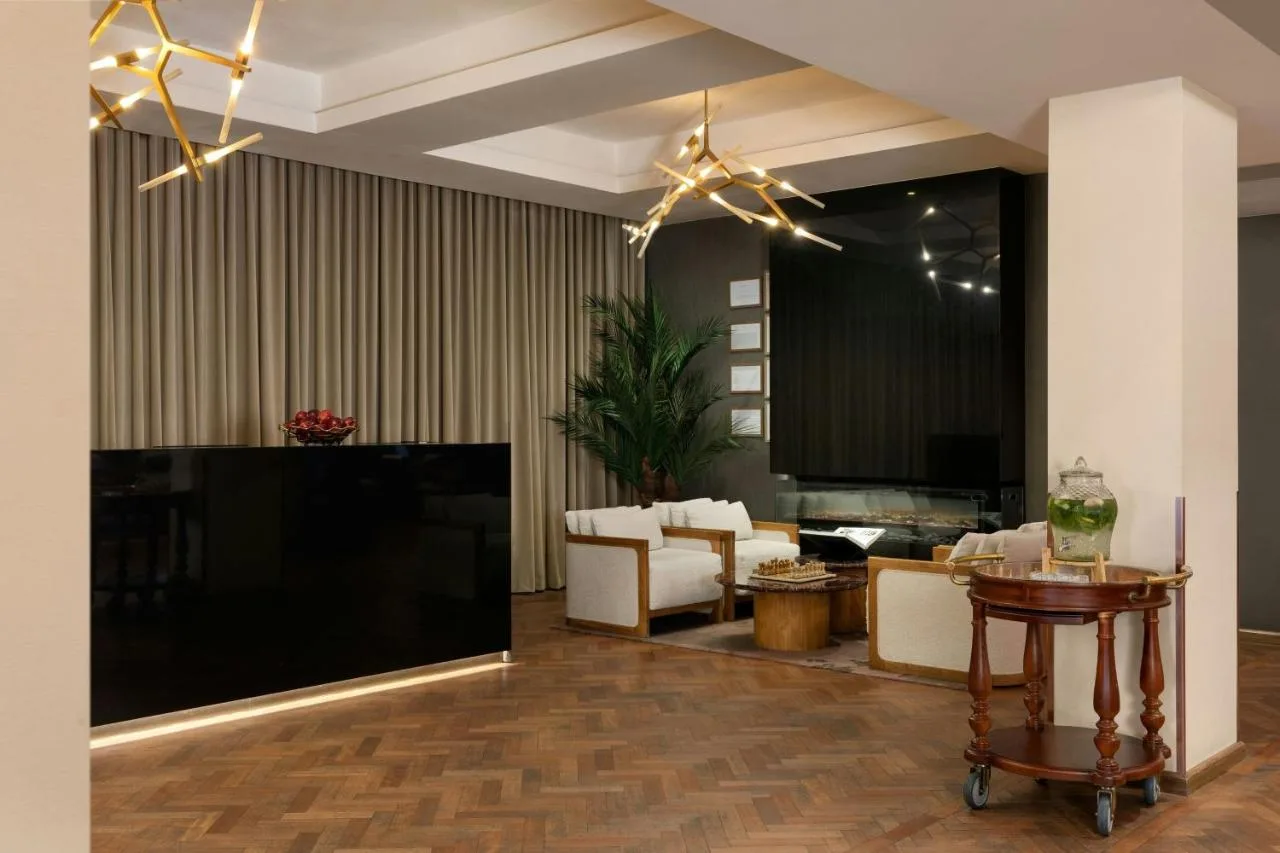 Suite living room with large screen TV at Montcalm Royal London House, London